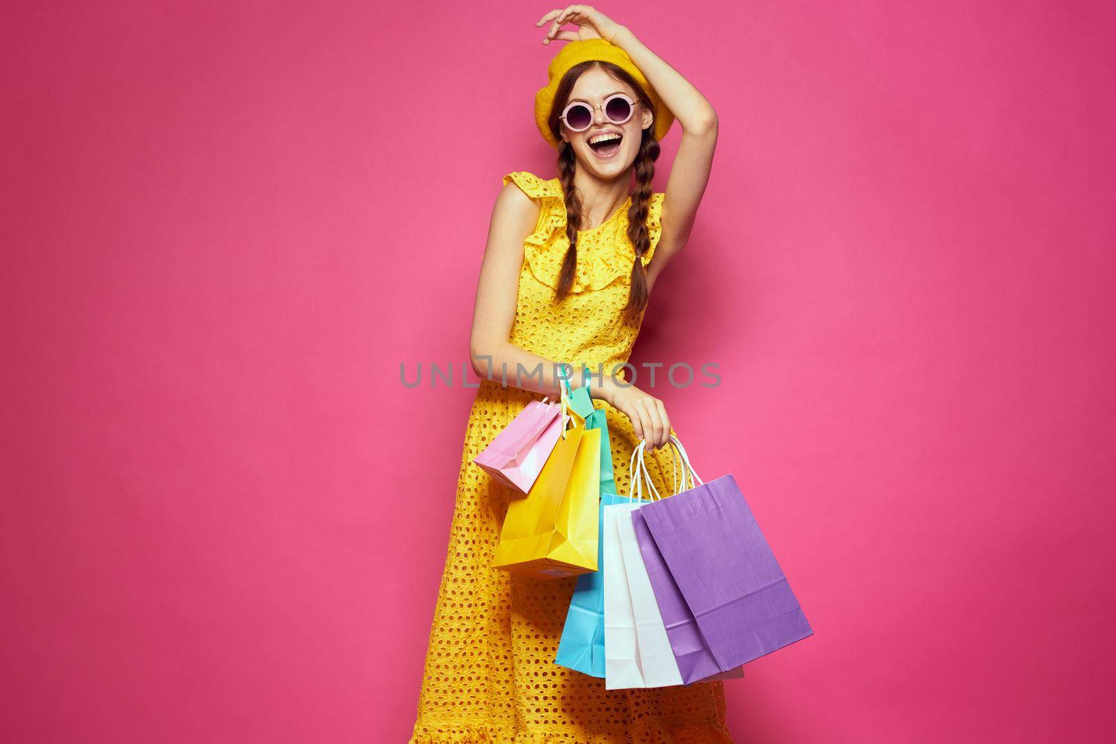 smiling woman in a yellow hat Shopaholic fashion style studio model. High quality photo