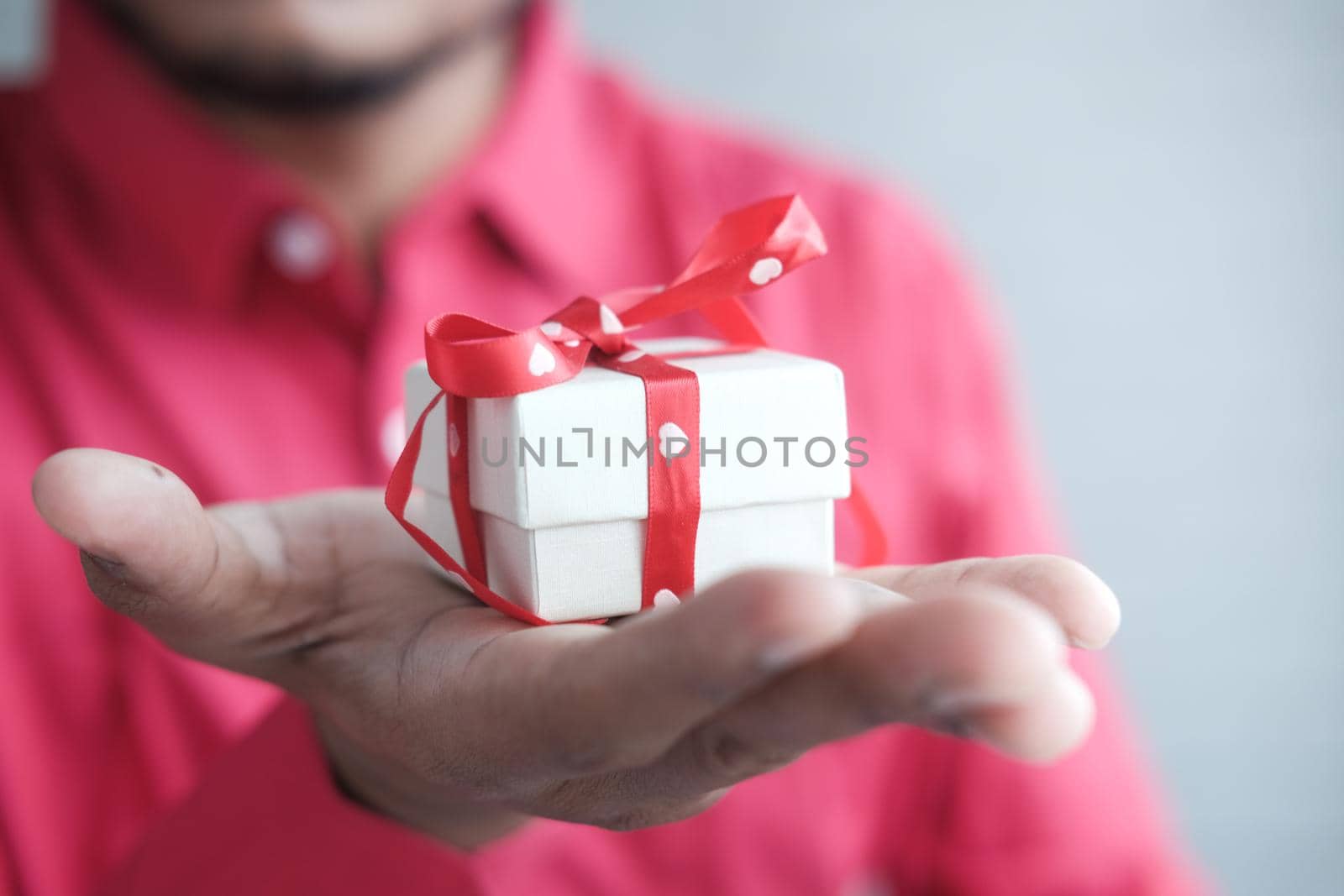 male hand holding gift box, closeup by towfiq007