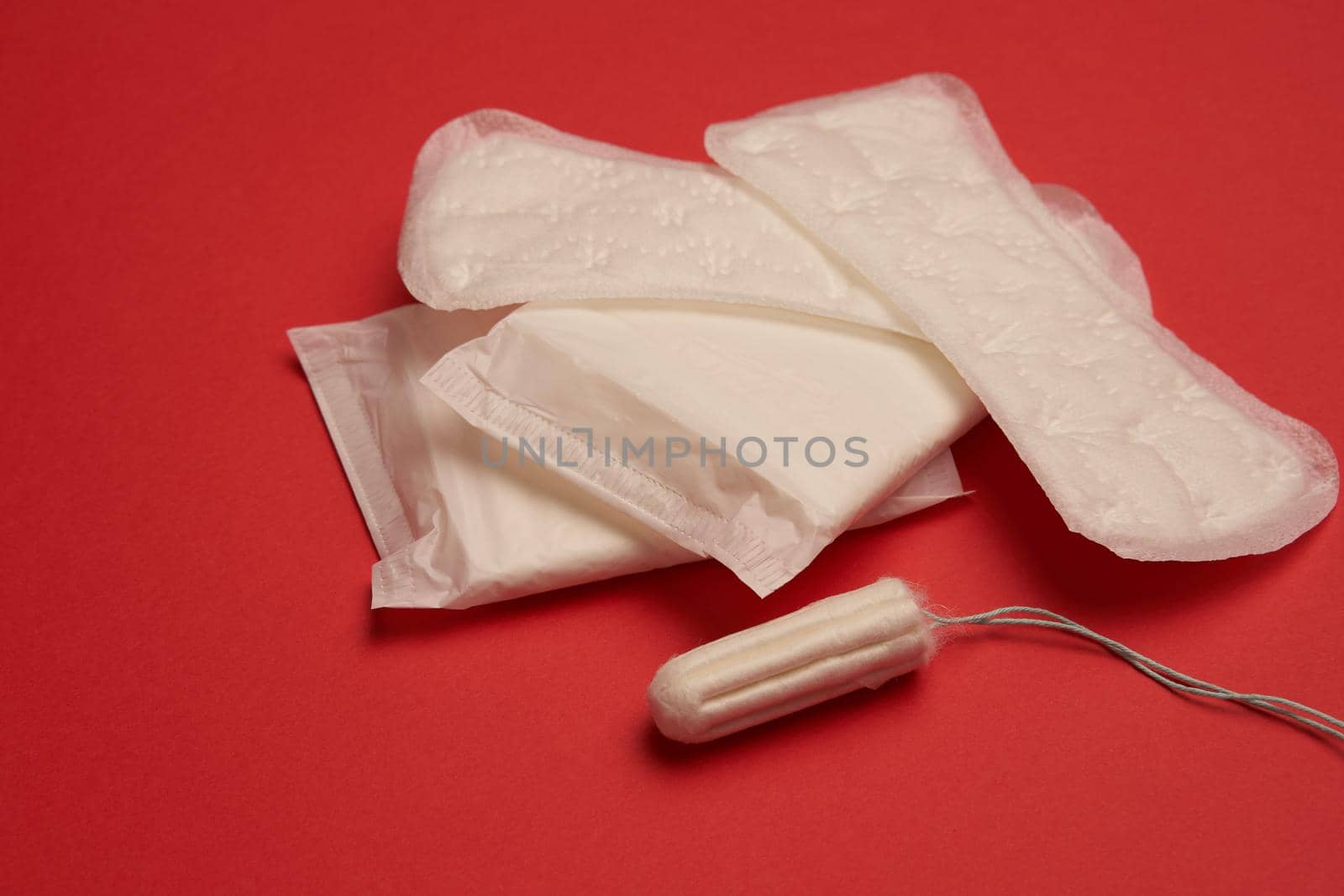 pads tampons underwear feminine hygiene red background. High quality photo