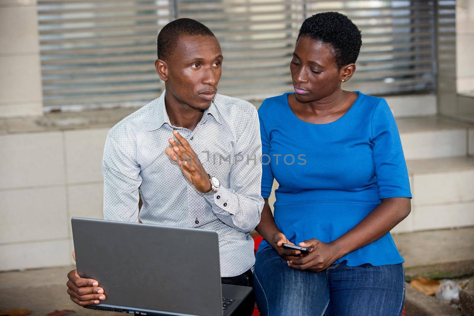 young people sitting with laptop thinking.