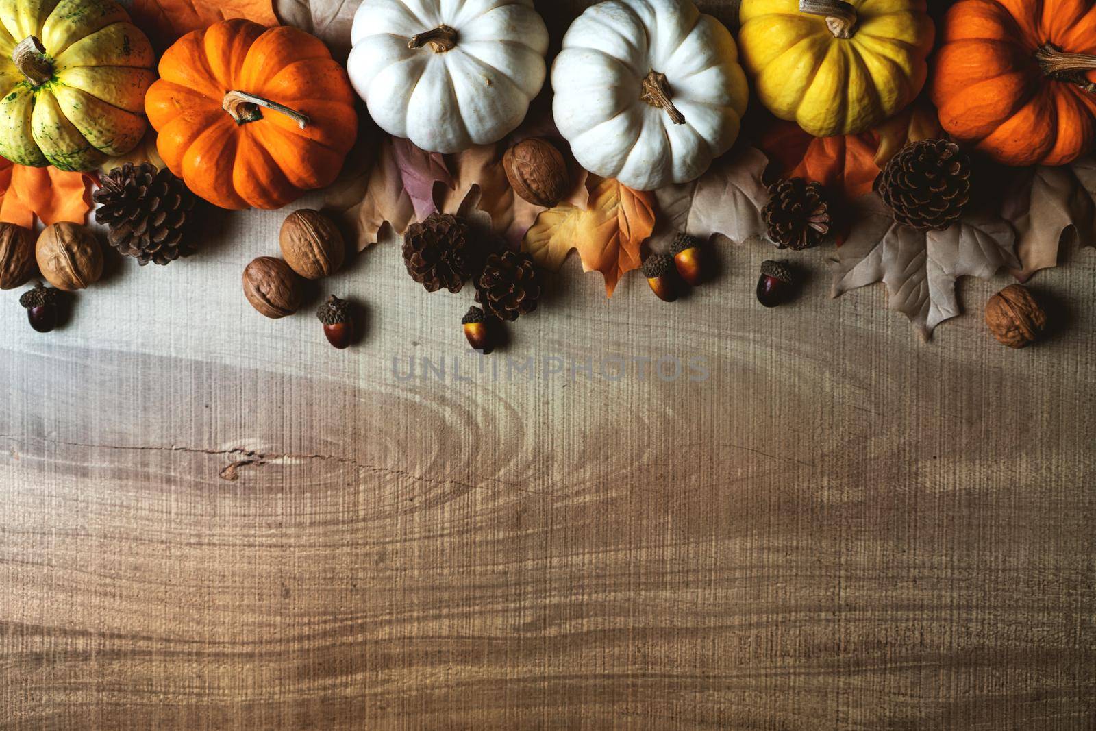 Happy Thanksgiving Day with pumpkin and nut on wooden table