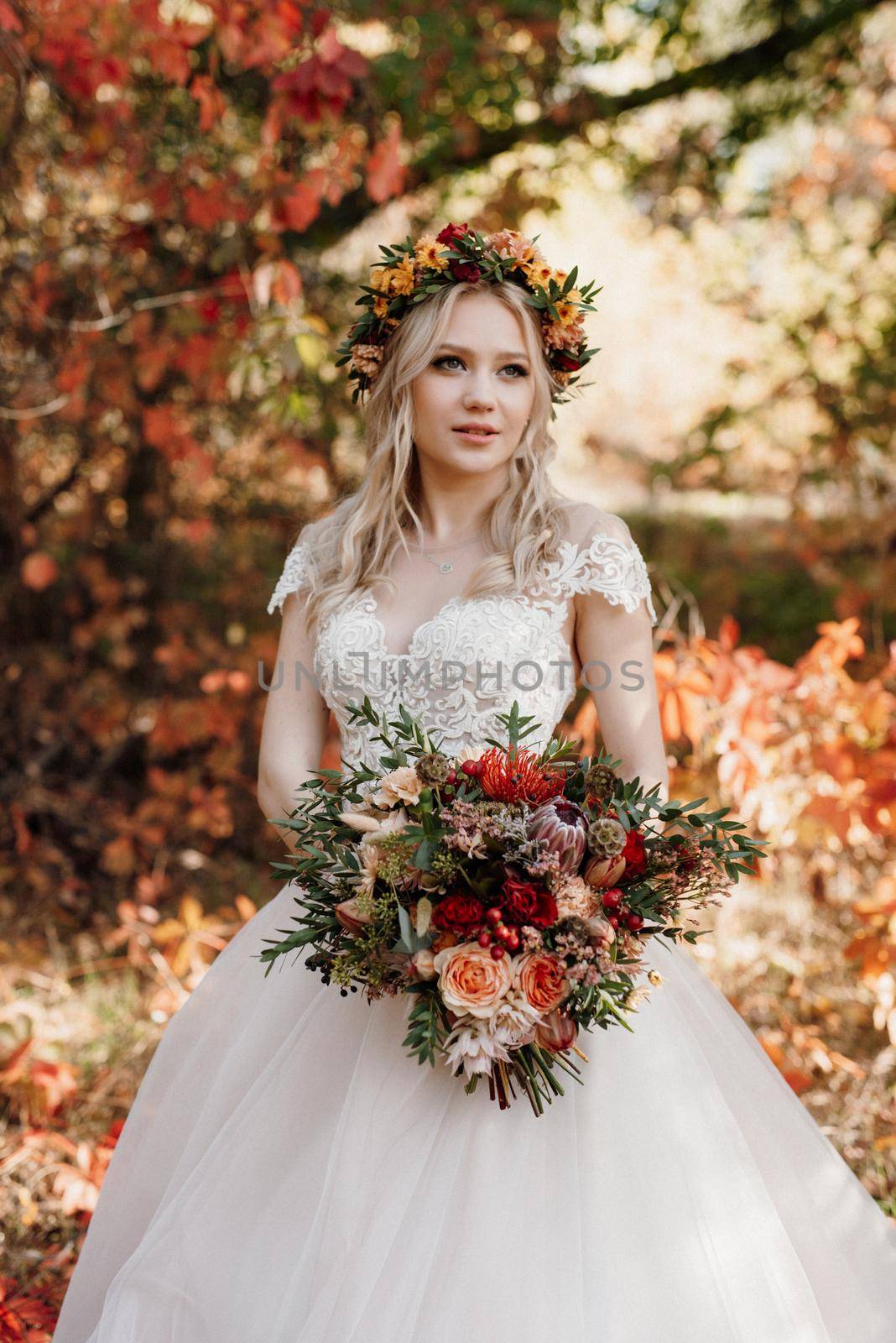 blonde girl in a wedding dress in the autumn forest by Andreua