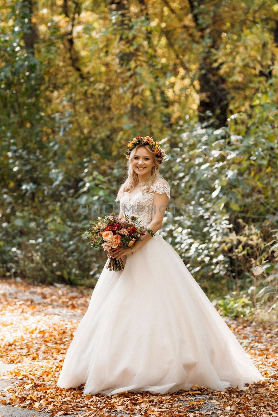 blonde girl in a wedding dress in the autumn forest by Andreua