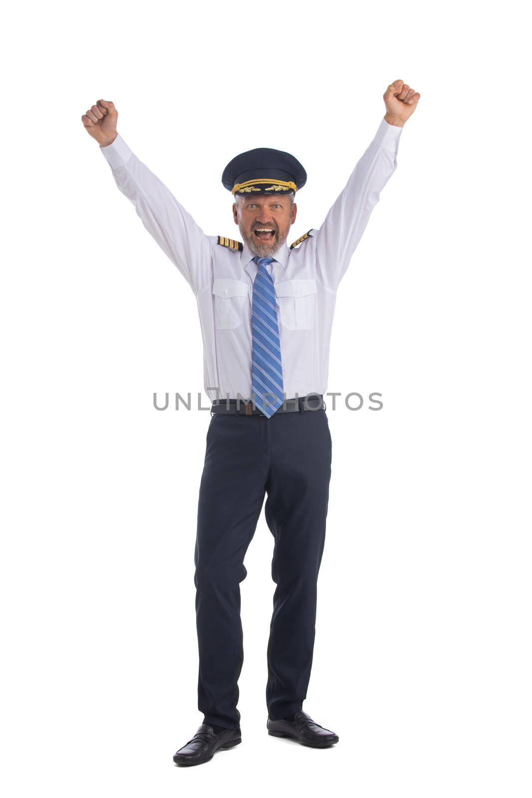 Airline pilot holds up his arms isolated on white background full length studio portrait