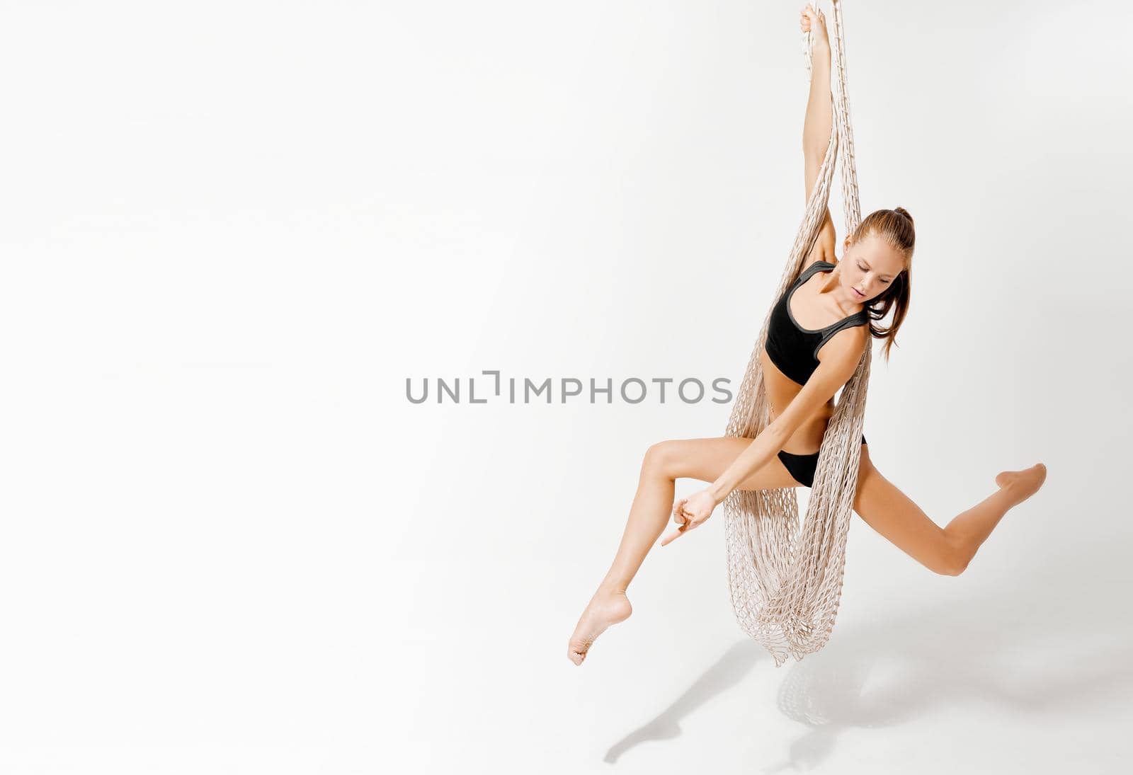 A person acrobat with net posing for a picture on white background high