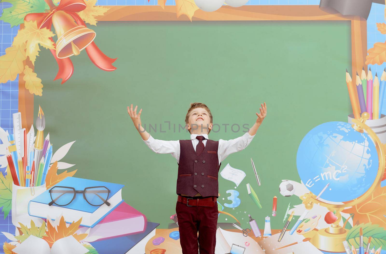 first day of school the boy stands in front of the board with his hands up by AntonIlchanka