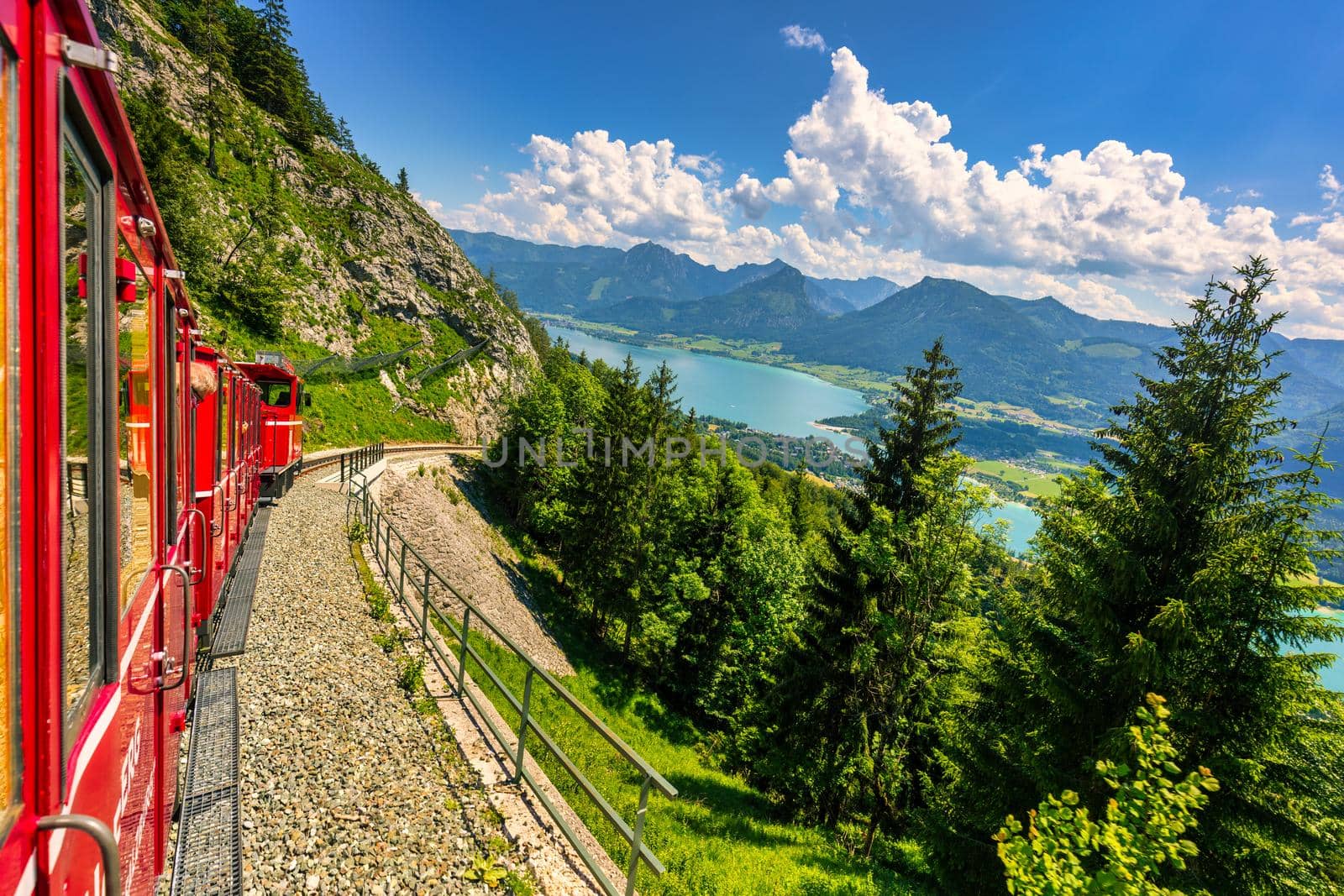 Schafbergbahn mountain train, Schafberg mountain, Salzkammergut region, Salzburg Land state, Austria. Journey to the top of Alps through lush fields and green forests.View of lake Wolfgangsee.