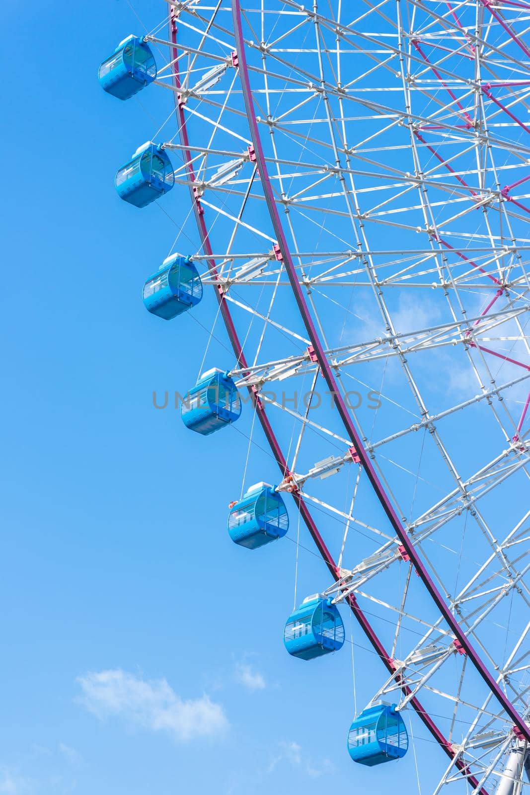 closeup ferris wheel against blue sky