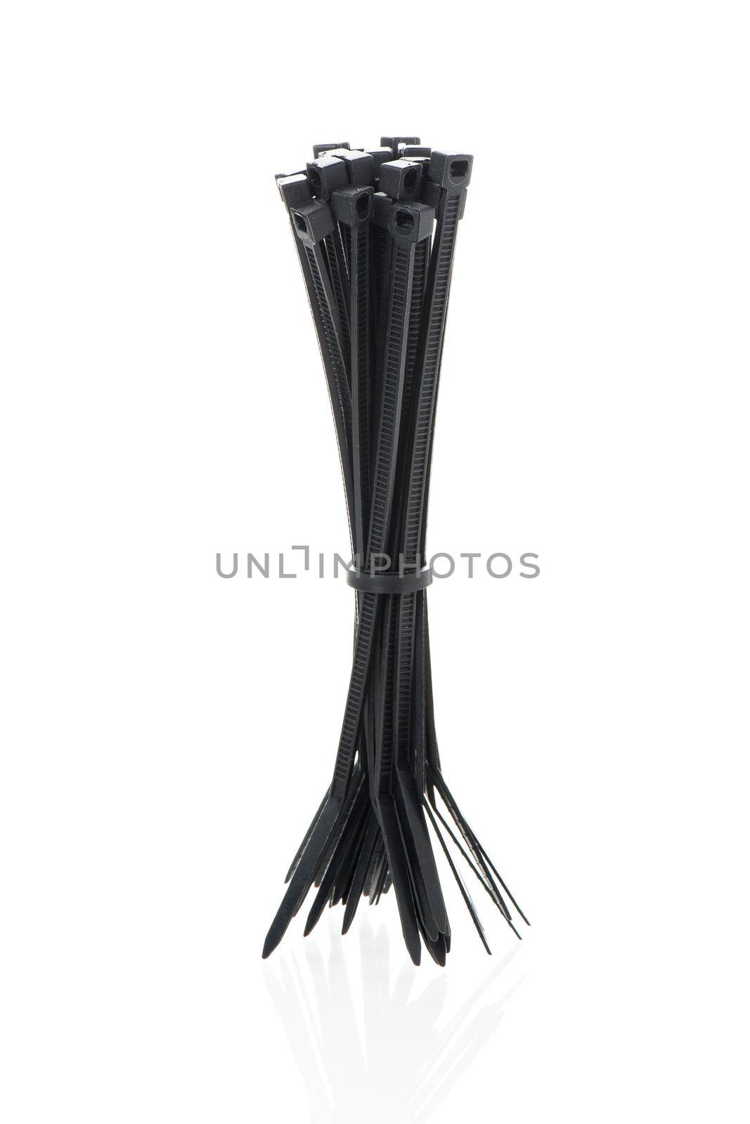 heap of black cable ties on white background
