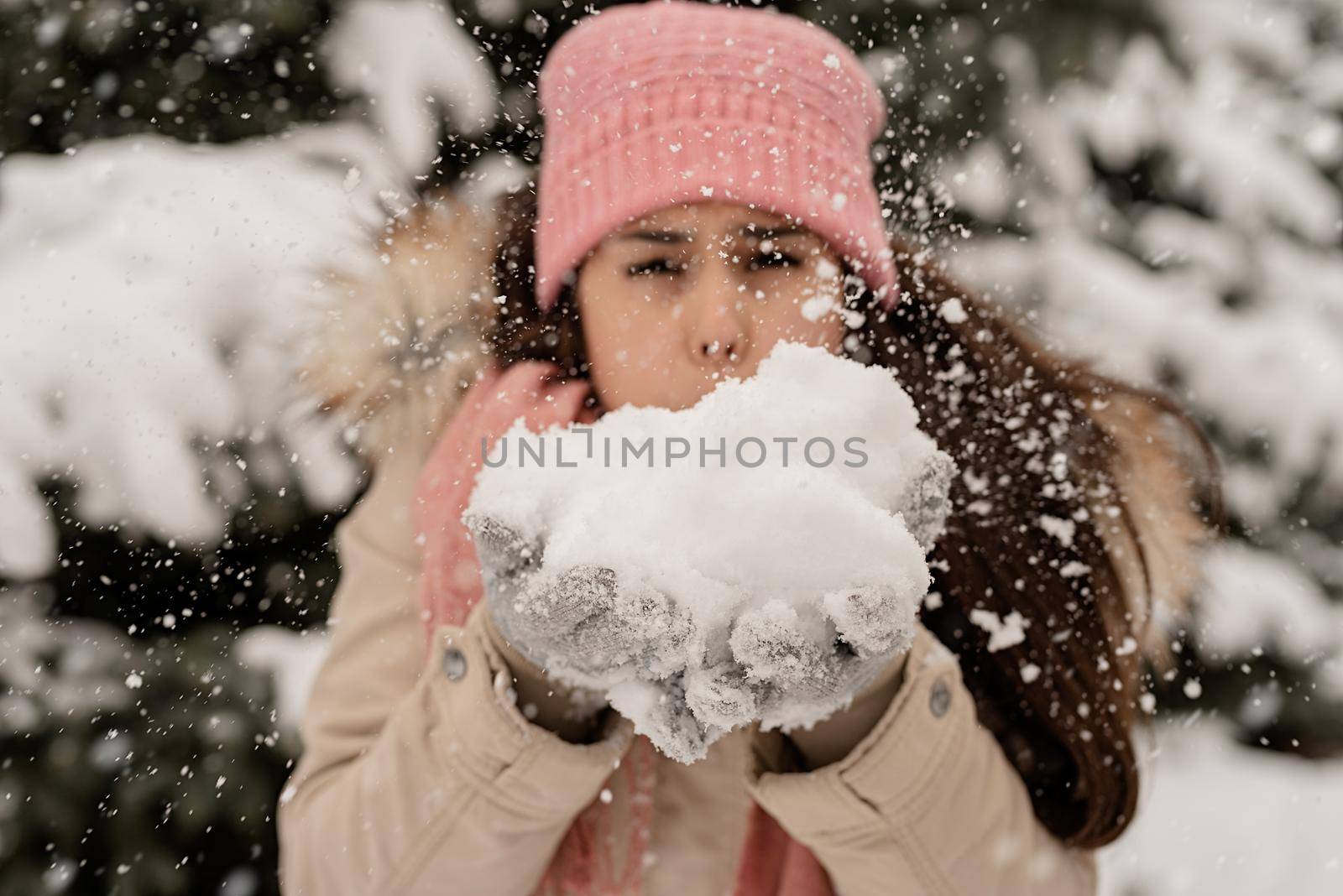 Close up of brunette Woman Blowing Snow by Desperada