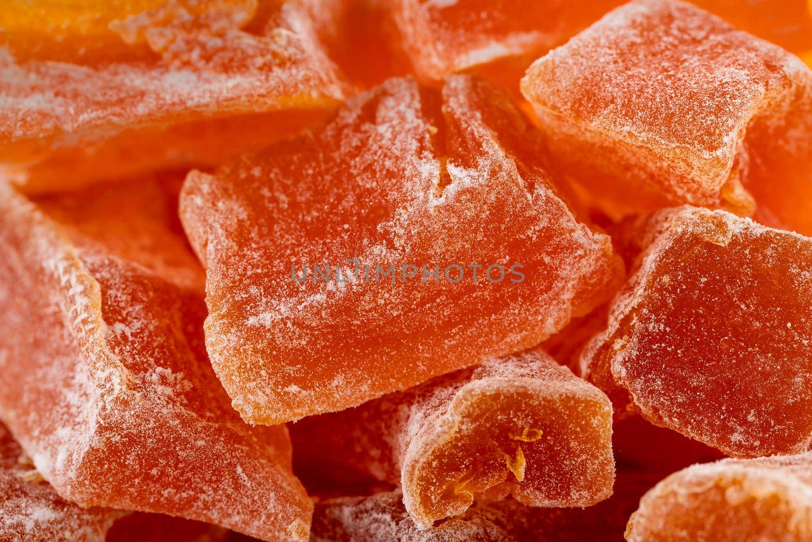 Close-up of Natural farm homemade candied pumpkin fruits sprinkled with powdered sugar, food background, texture.