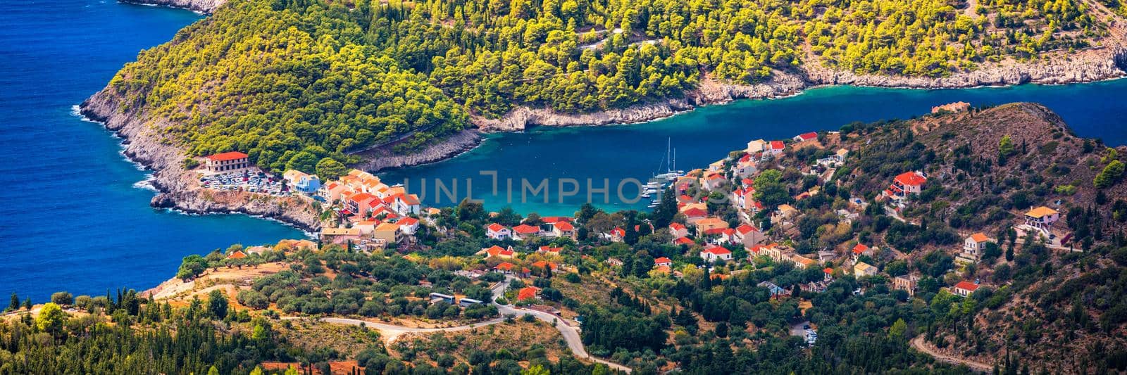 Assos village in Kefalonia, Greece. Turquoise colored bay in Mediterranean sea with beautiful colorful houses in Assos village in Kefalonia, Greece, Ionian island, Cephalonia, Assos village.