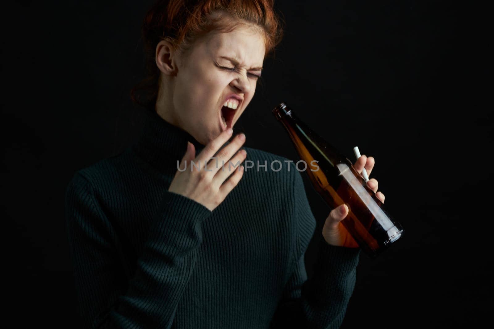 woman with bottle of alcohol bruises under eyes changes depression dark background by Vichizh