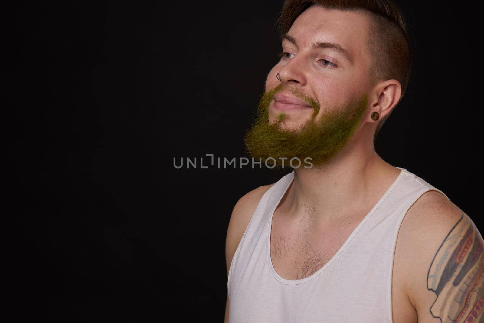 stylish bearded man in a white t-shirt with tattoos on his arms fashion by Vichizh