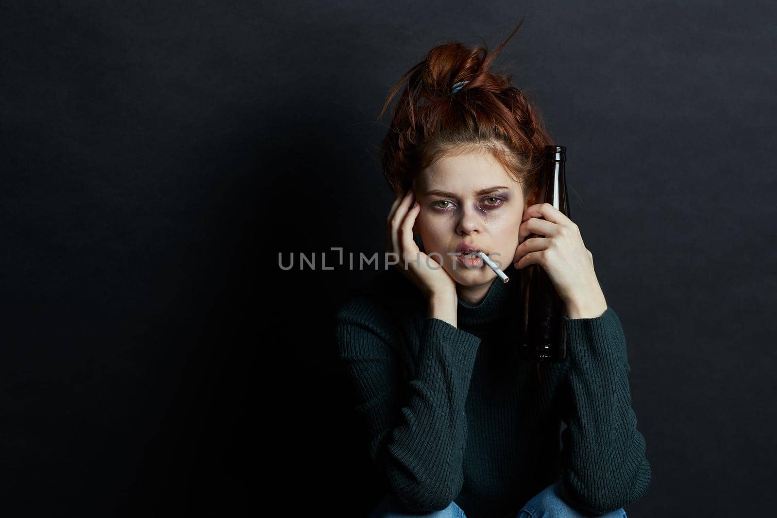 woman with bottle of alcohol smokes a cigarette depression bruises under eyes emotions. High quality photo