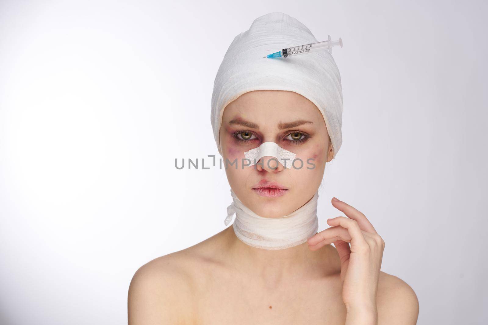 emotional woman plastic surgery operation bare shoulders light background. High quality photo