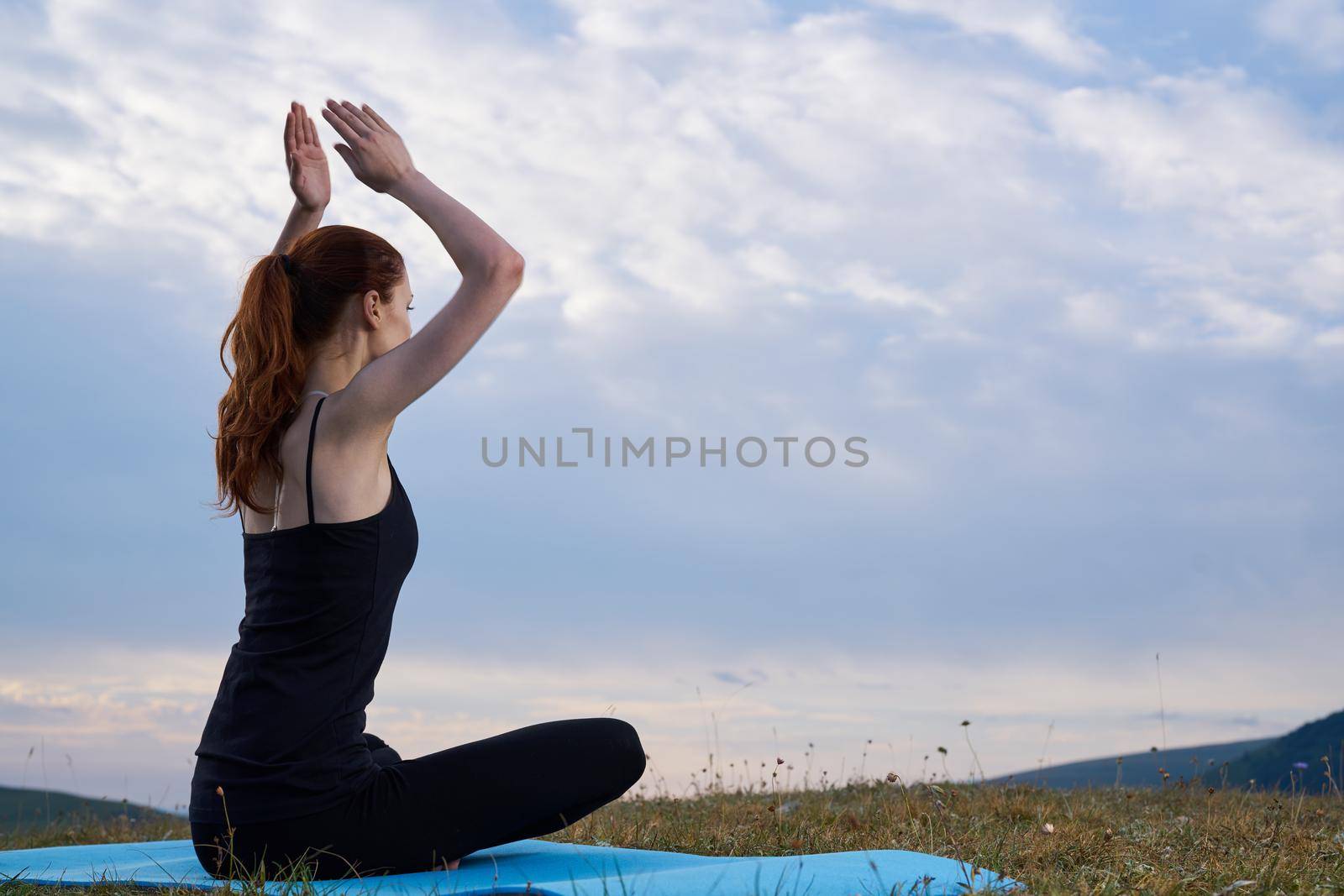 sportive woman workout meditation in the mountains outdoors. High quality photo