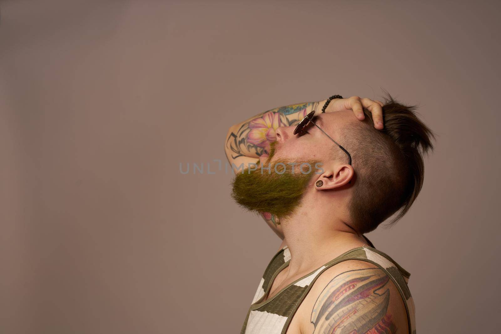 bearded man in striped t-shirt glasses tattoo on his arms fashion by Vichizh