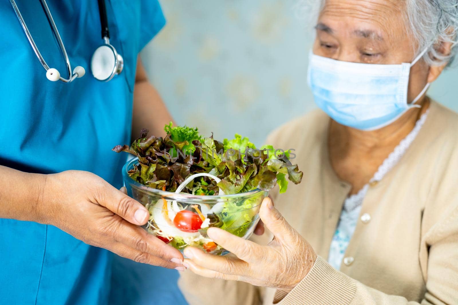 Doctor and Asian senior or elderly old lady woman patient holding breakfast vegetable healthy food with hope and happy while sitting and hungry on bed in hospital.