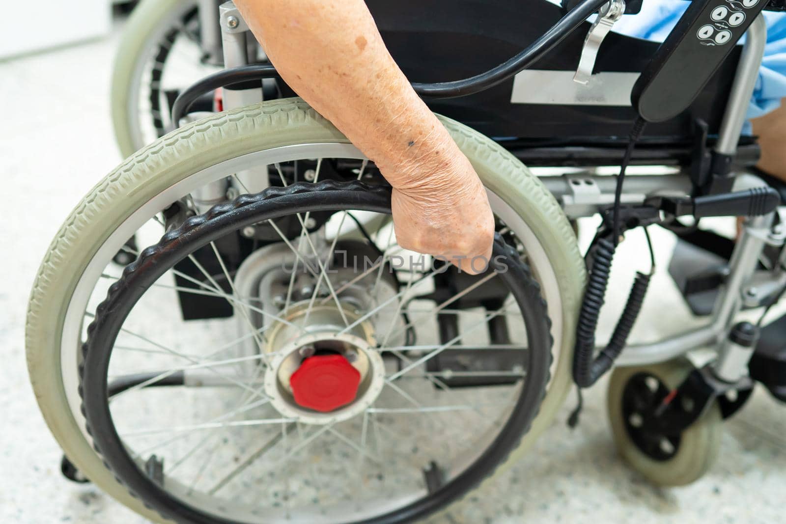 Asian senior or elderly old lady woman patient on electric wheelchair with remote control at nursing hospital ward, healthy strong medical concept