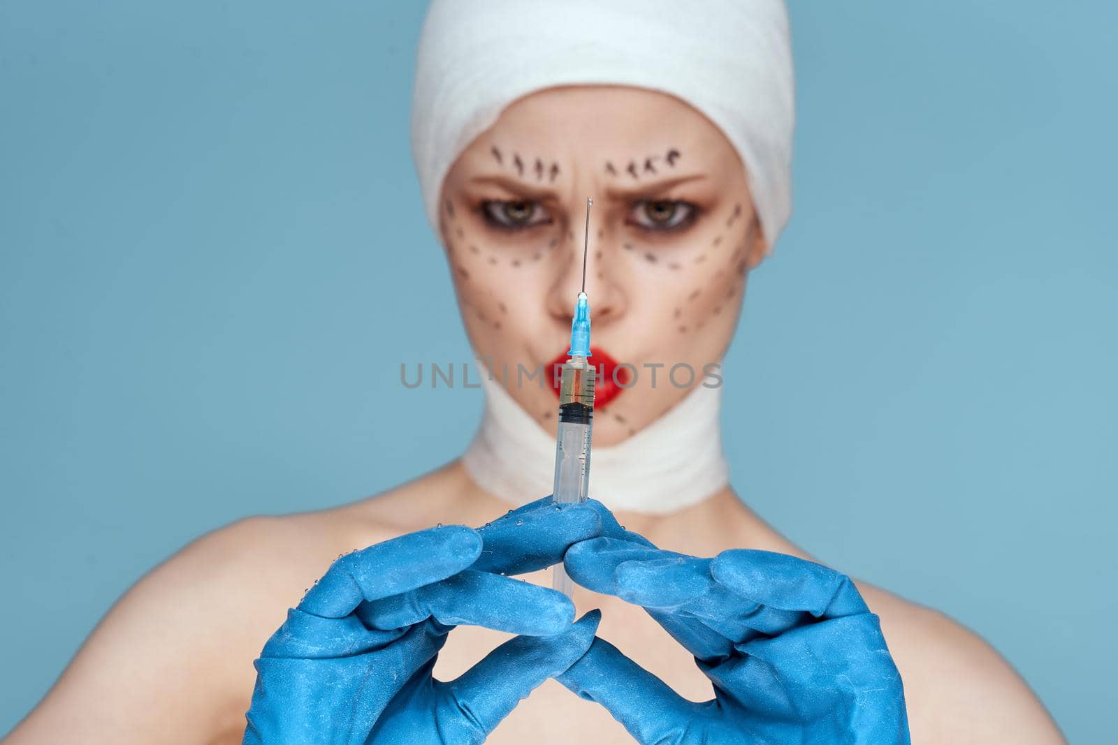 female patient posing in blue gloves red lips surgery facial rejuvenation close-up by Vichizh