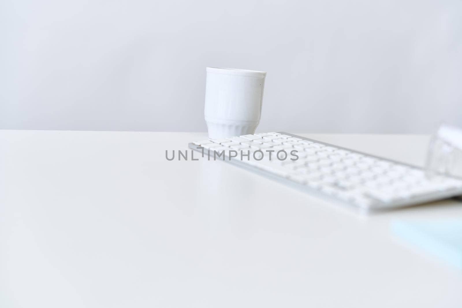 wireless keyboard on desktop cup documents office. High quality photo