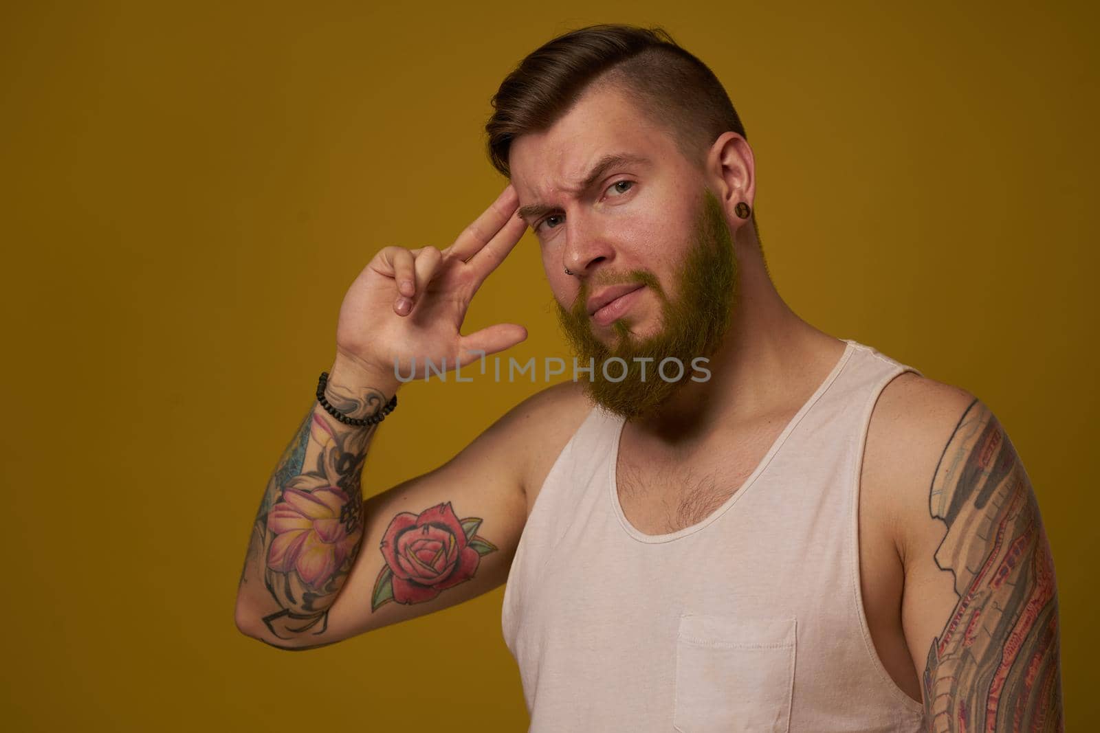 macho man in white t-shirt tattoos on his arms posing isolated background by Vichizh