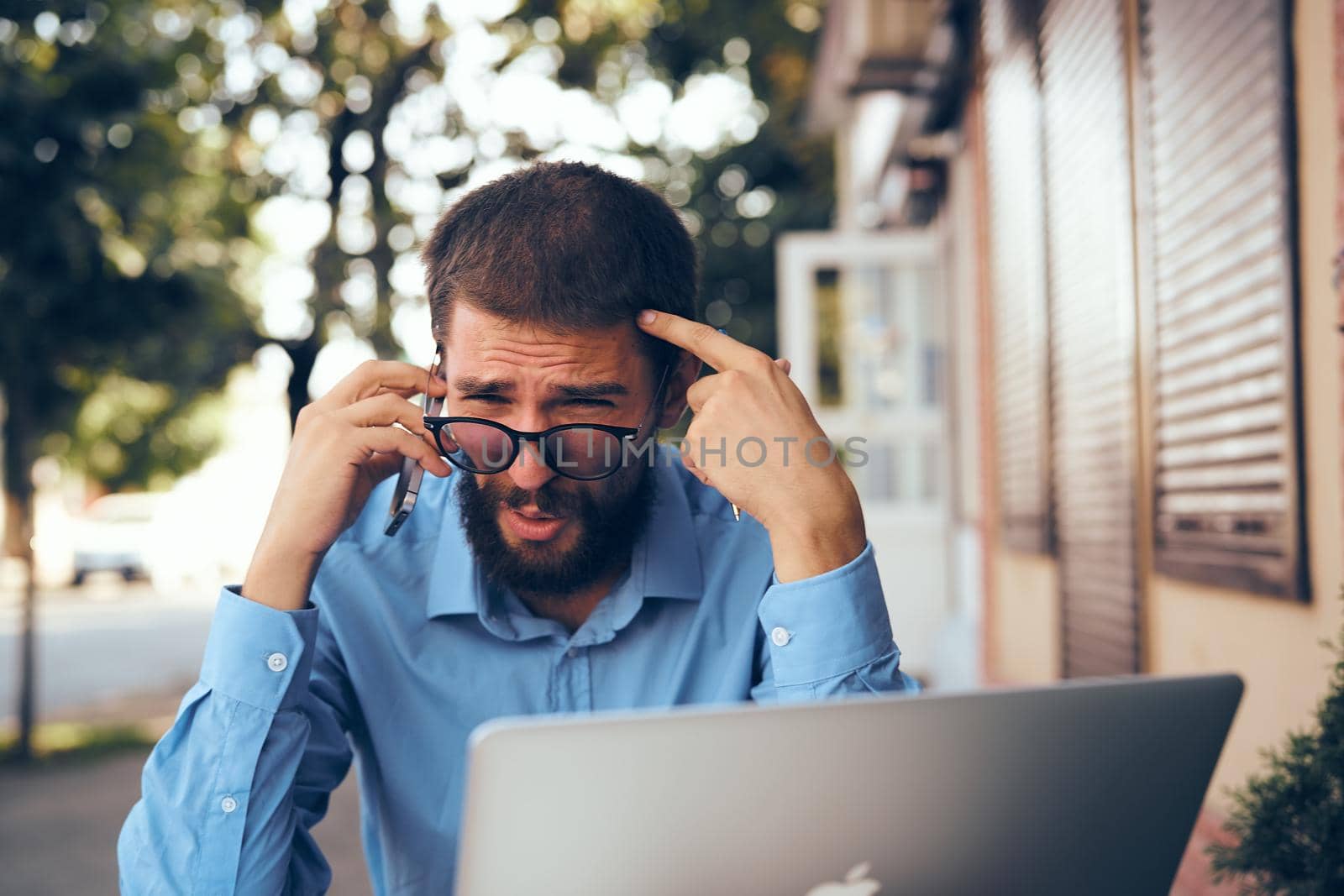 bearded man with laptop in cafe working. High quality photo