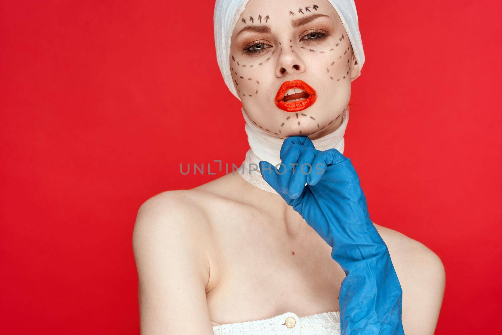 a person in blue gloves syringe in hands contour on the face lifting close-up. High quality photo