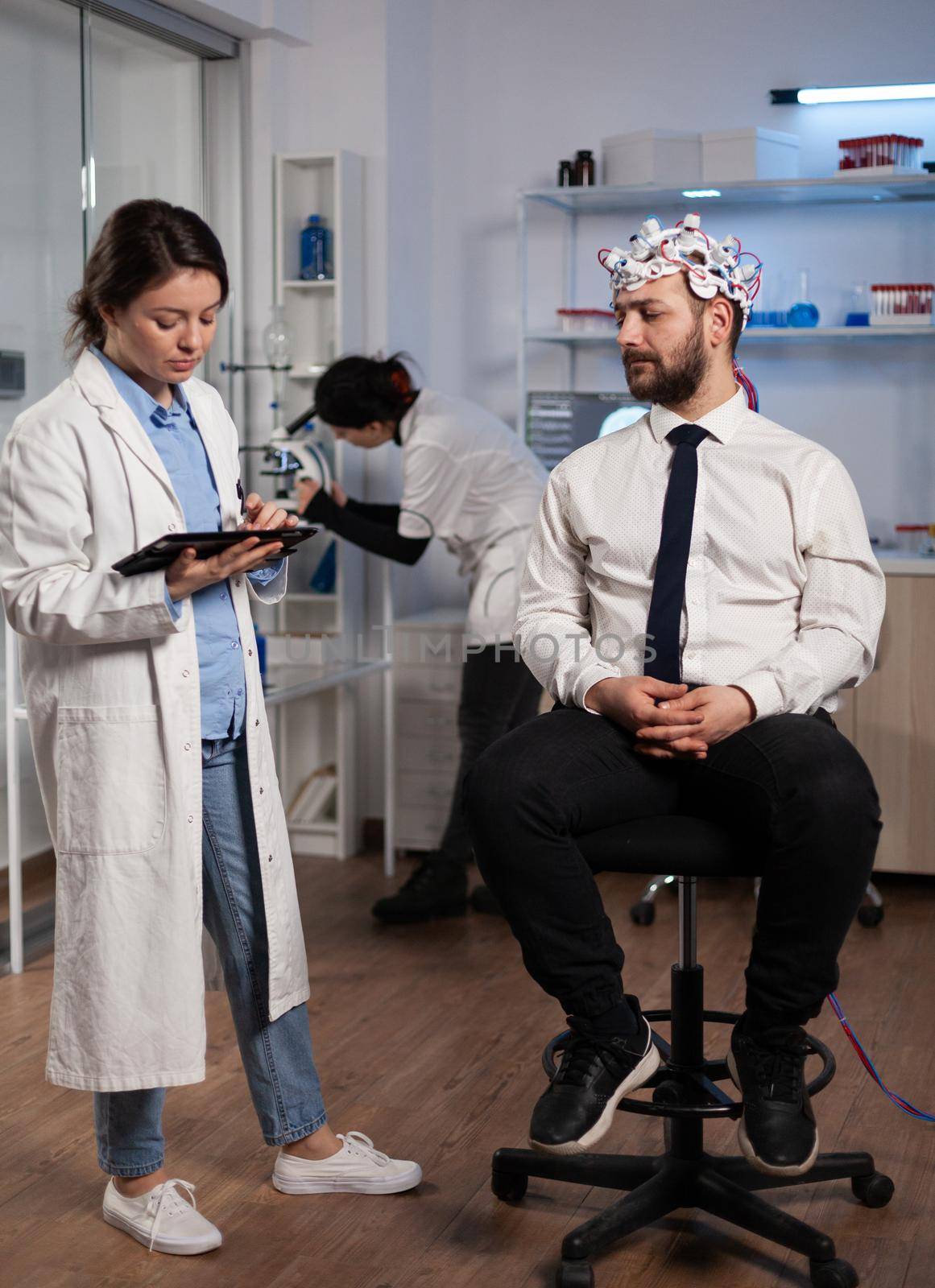 Neurologist woman monitoring brain evolution developing medical treatment for neurological disease in modern laboratory. Scientist doctor analyzing nervous system activity. Neurology service