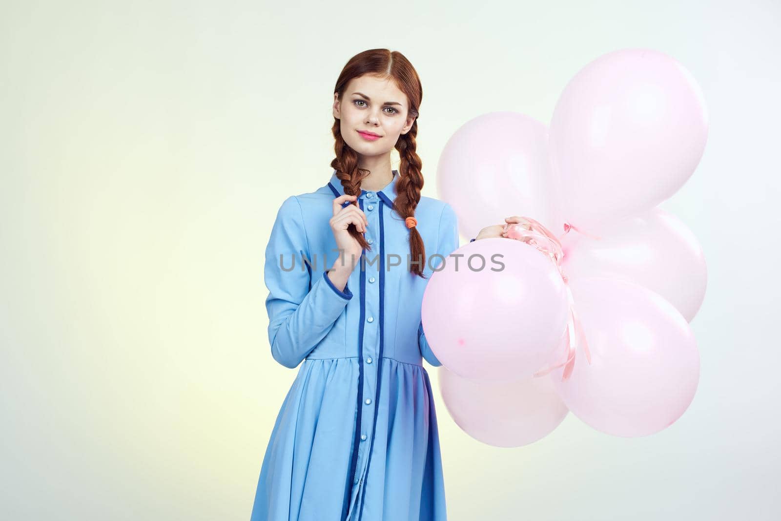 pretty woman with pigtails decoration holiday fun light background. High quality photo