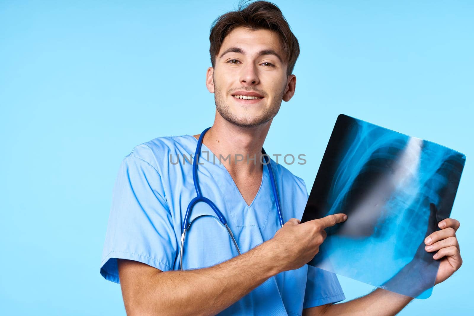 male doctor x-ray diagnostics stethoscope examination work blue background. High quality photo