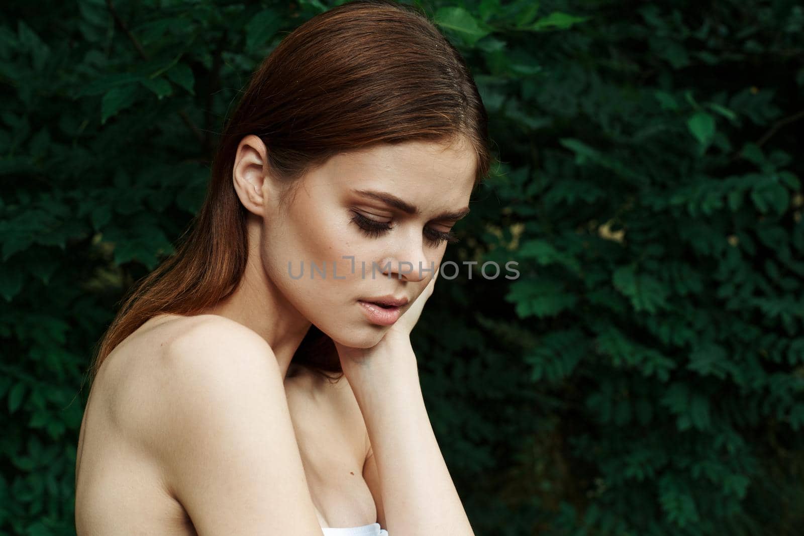 portrait of a woman Cosmetology nature green leaves glamor cropped view. High quality photo