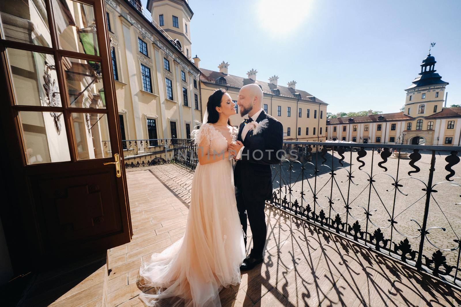 Elegant wedding couple on the balcony of an old castle in the city of Nesvizh.