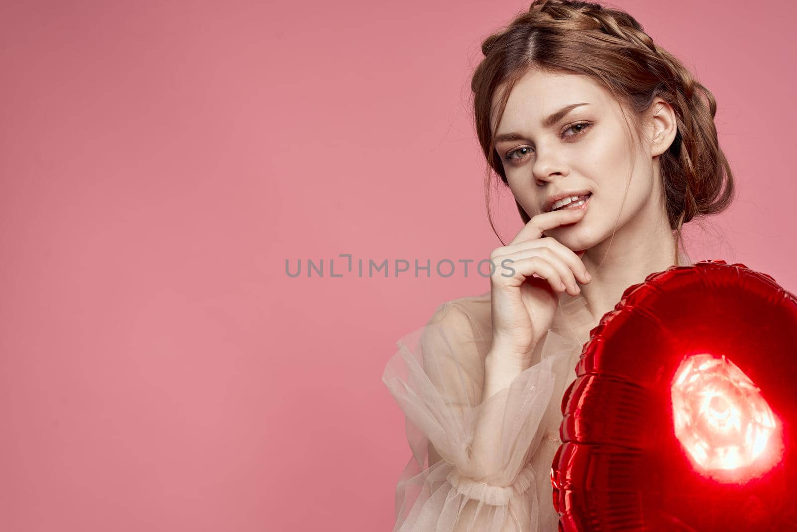 portrait of a woman red heart in the hands of the balloon isolated background. High quality photo