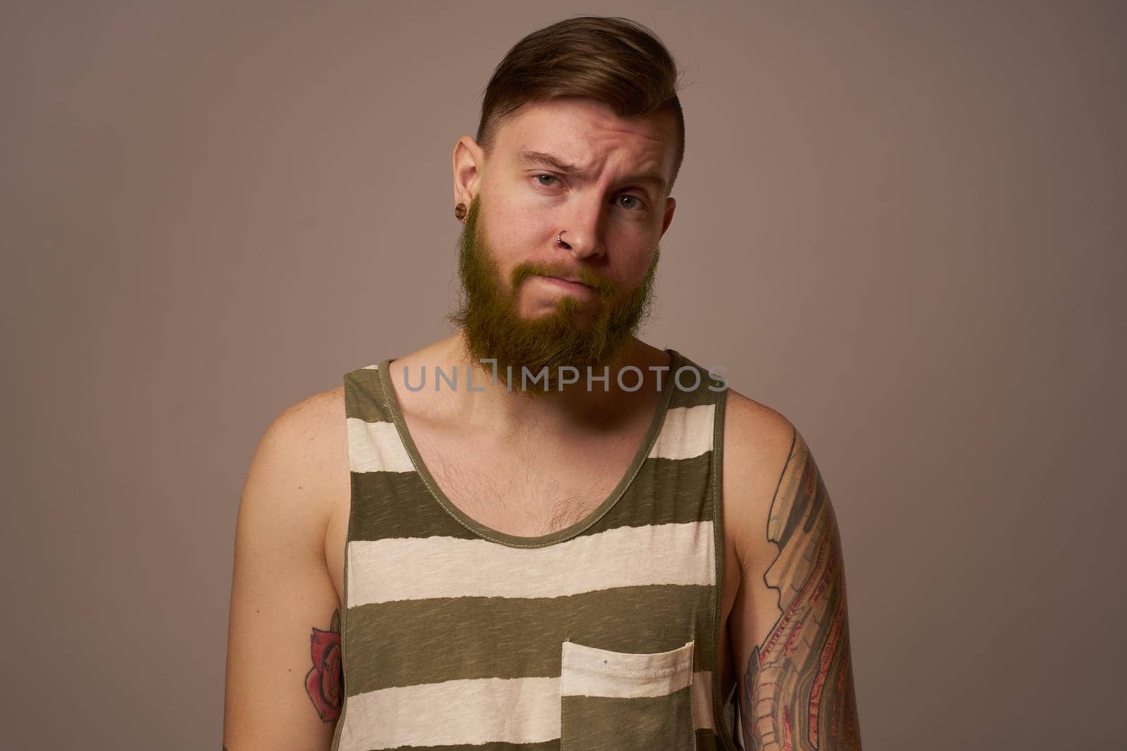 national bearded man in a striped jersey hipster tattoos on his arms by Vichizh