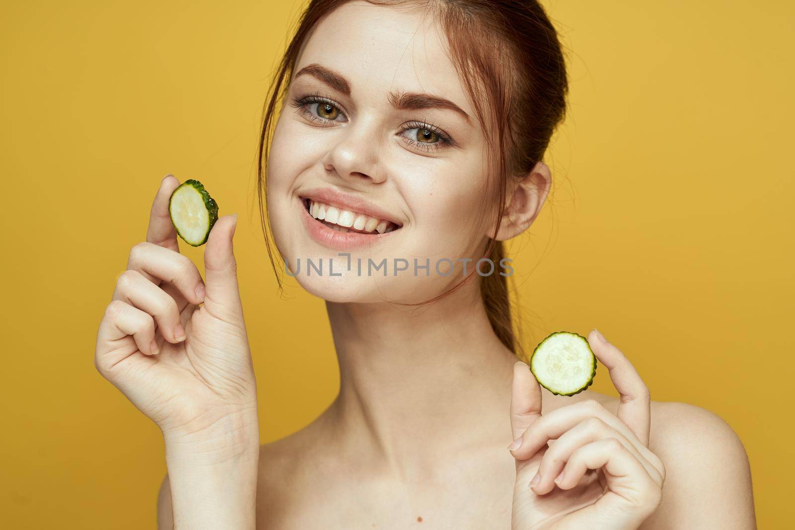 cheerful woman with cucumber vitamin skin care natural product. High quality photo