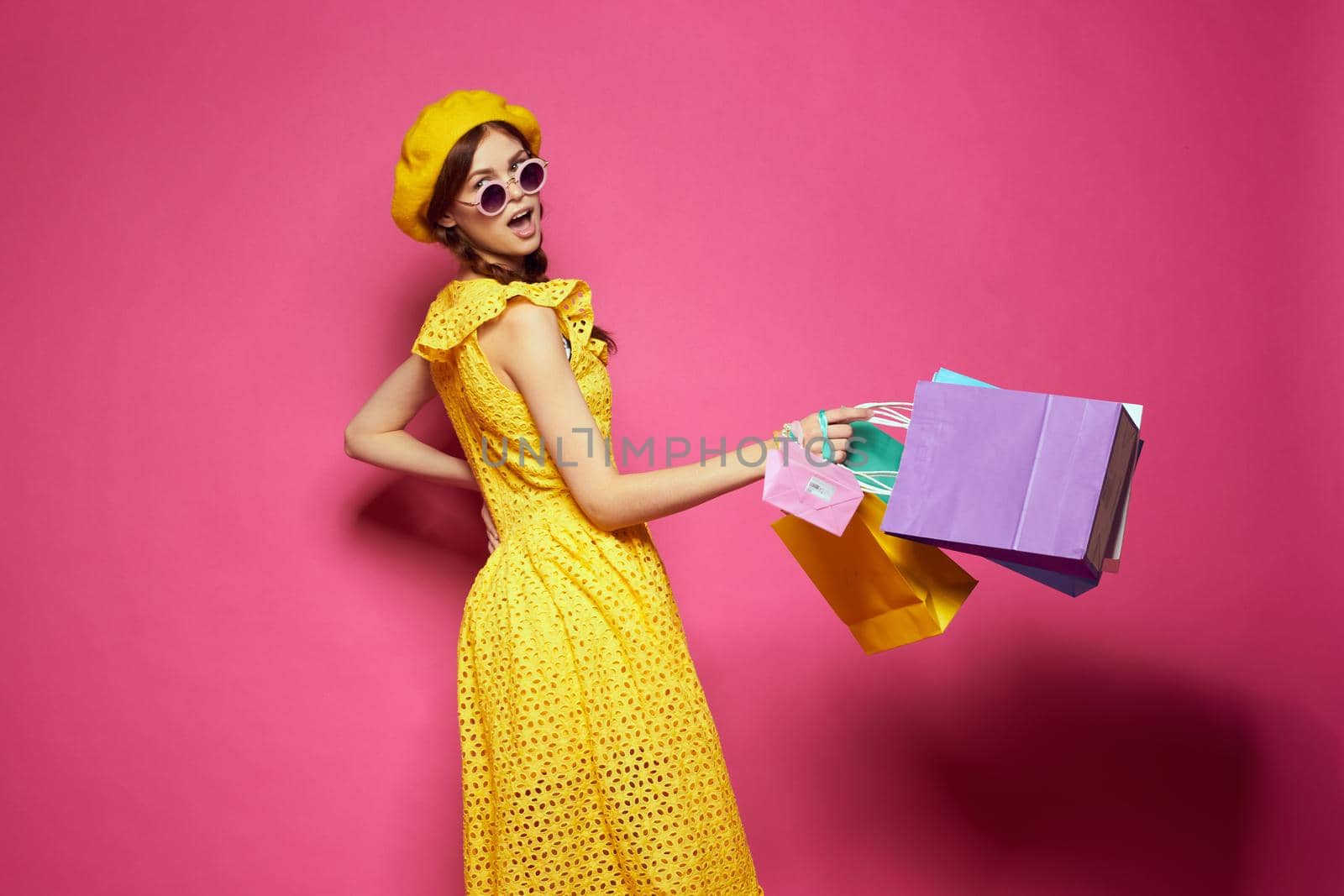 smiling woman with multicolored bags posing isolated background. High quality photo