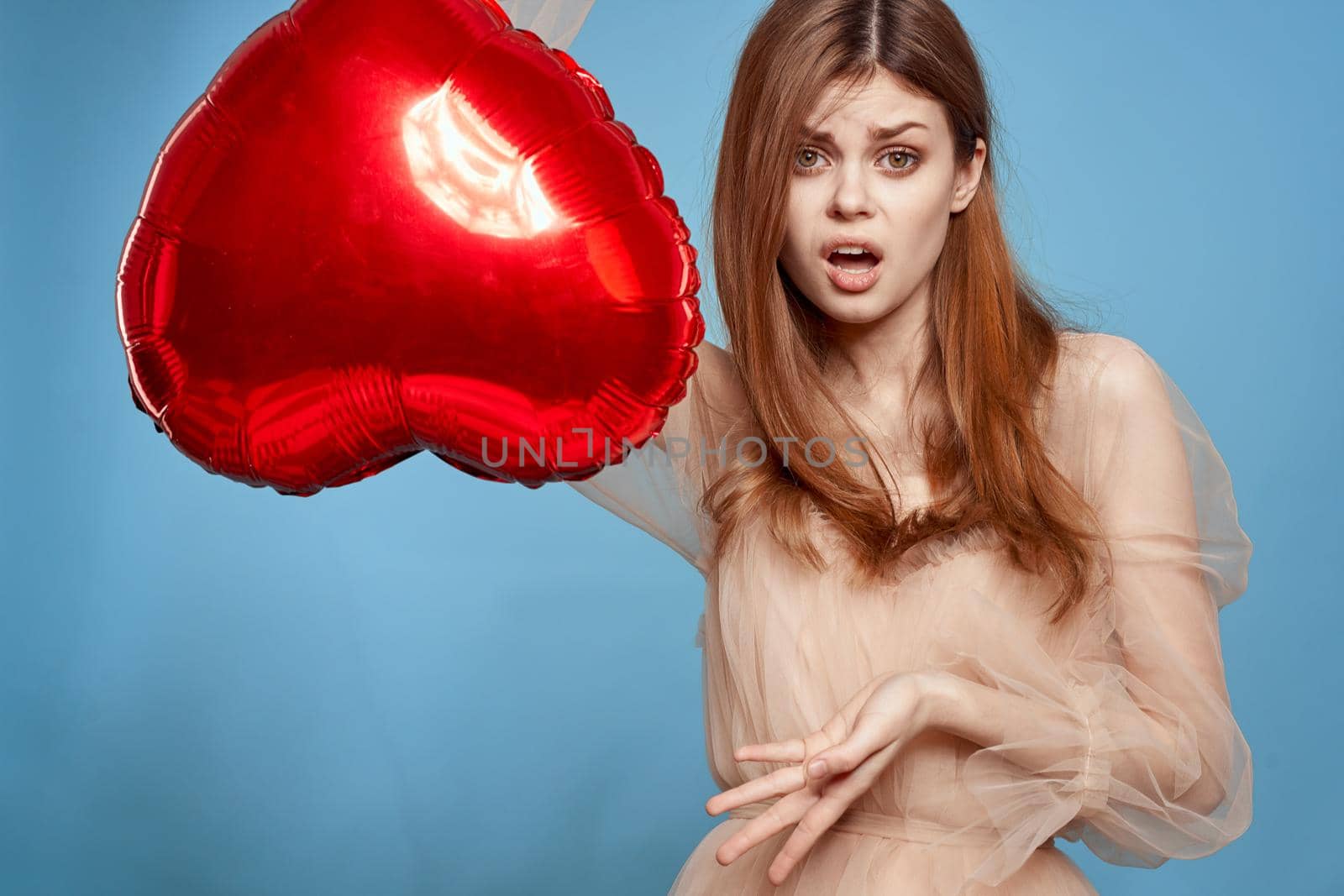 pretty woman red heart in the hands of the balloon isolated background. High quality photo