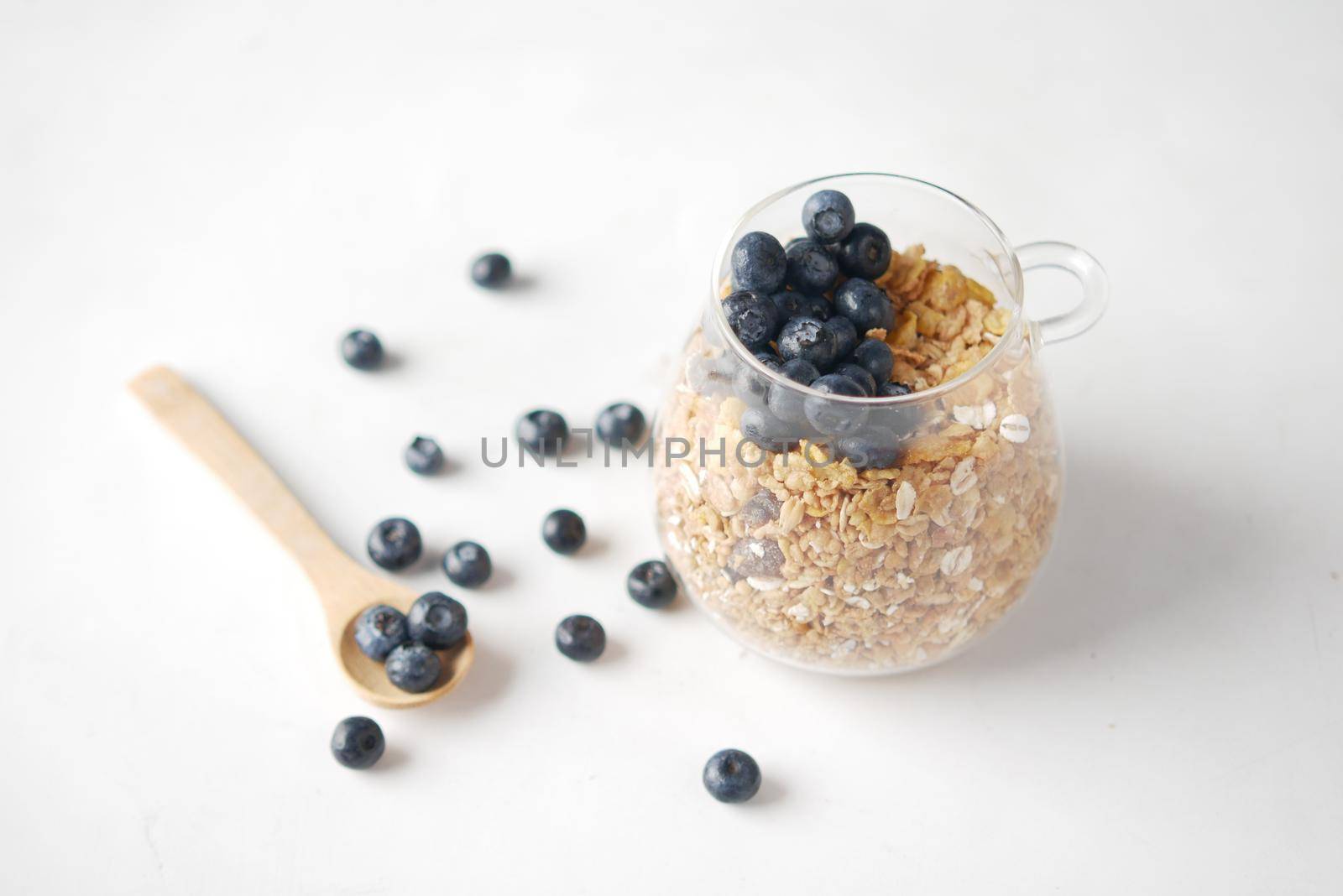 cereal breakfast and blue berry in bowl on table .