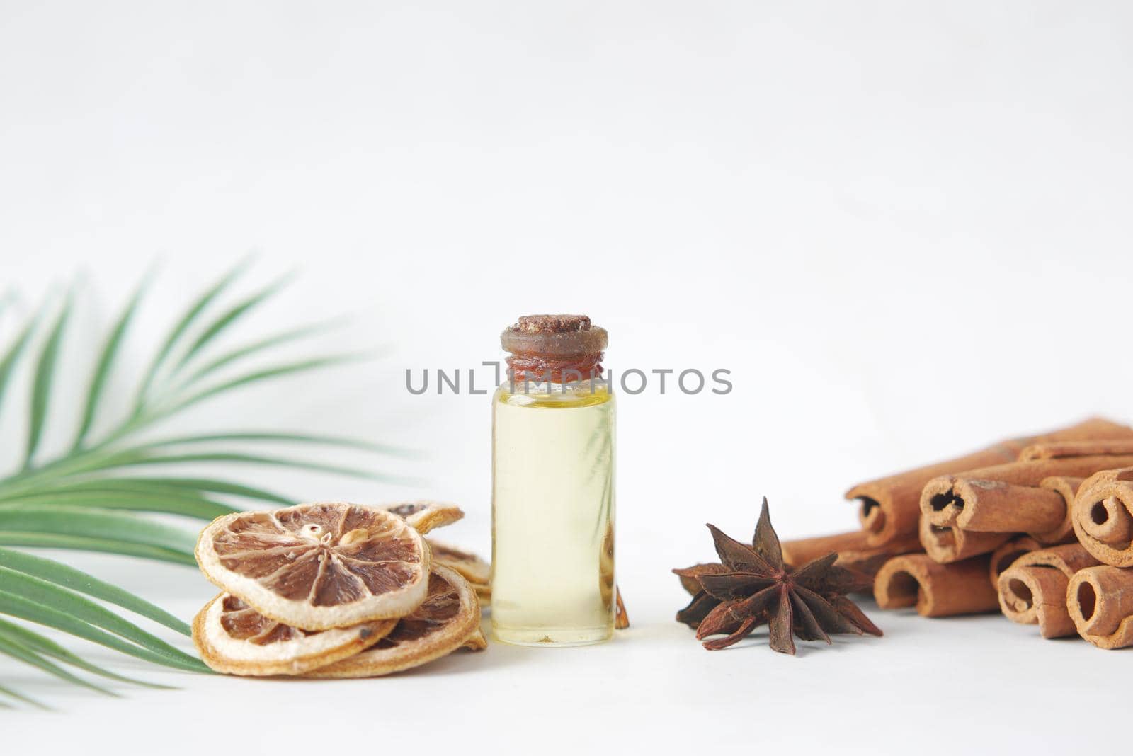 essential citrus oil, dried lemon and spice on table