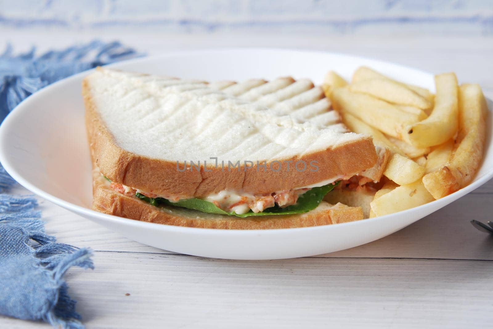 egg sandwich and chips on plate close up .