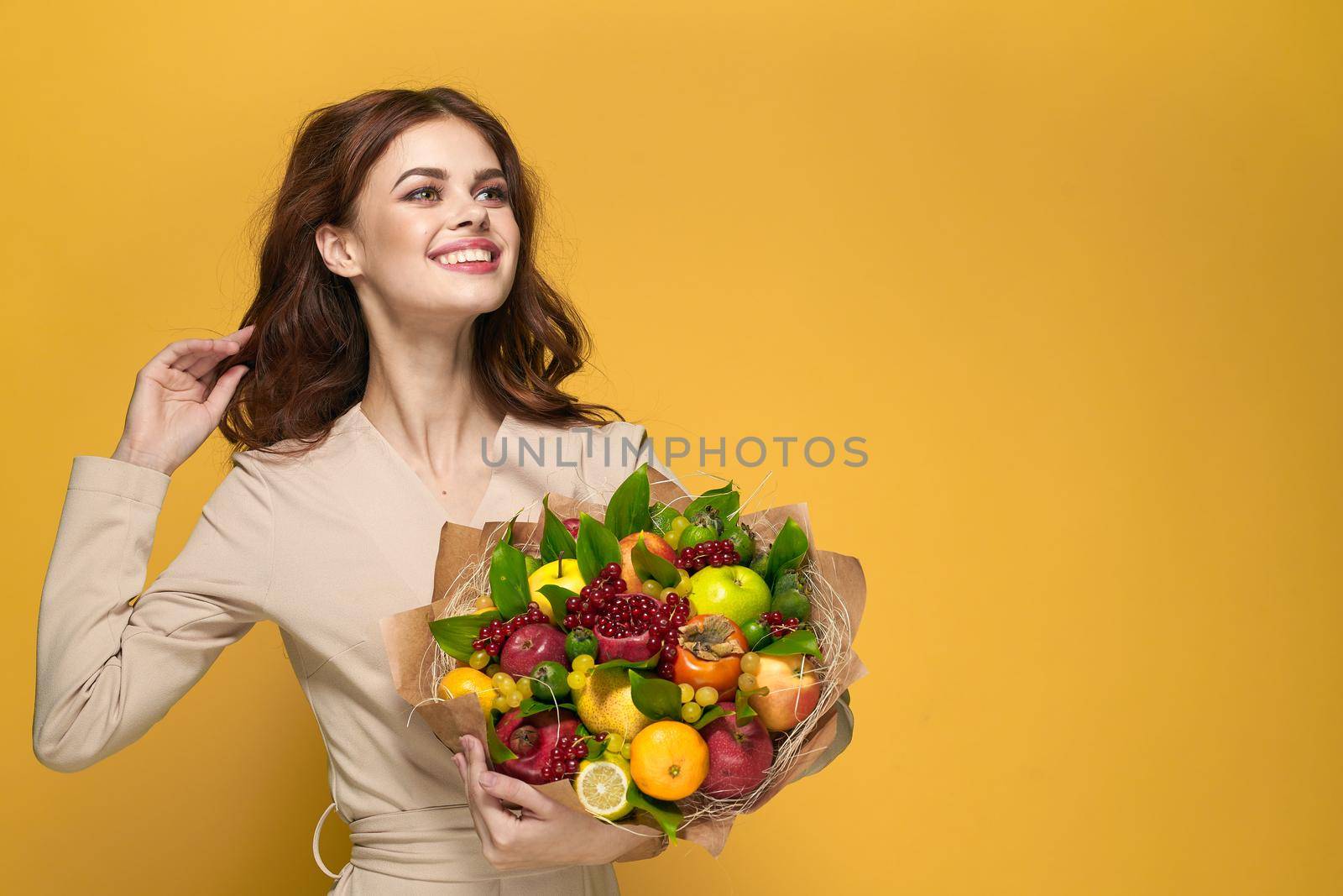 portrait of a woman fun posing fruit bouquet vitamins colorful background. High quality photo