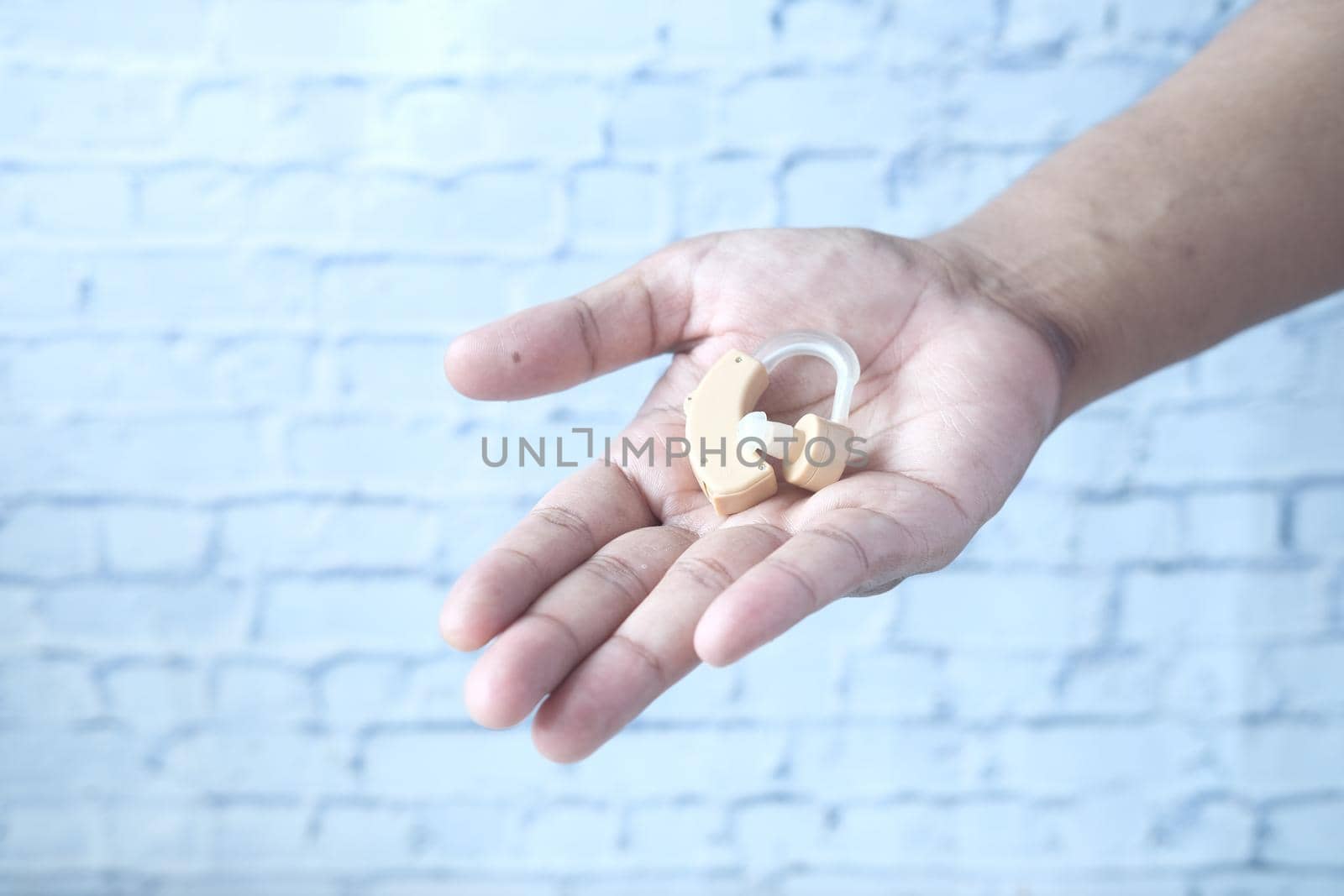 Hearing aid equipment on hand with copy space .