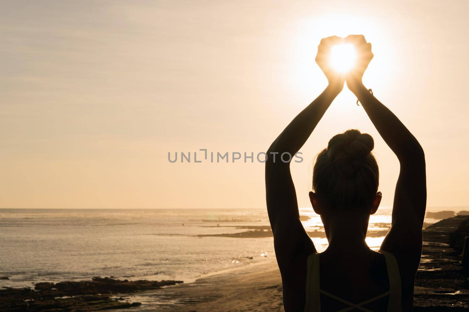 beautiful woman meditating outdoors. bali black beach