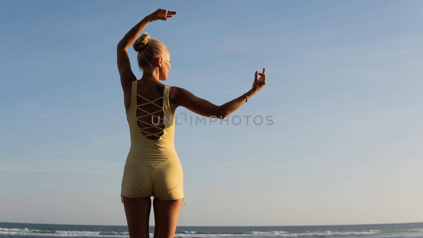 beautiful woman doing yoga on the beach. bali