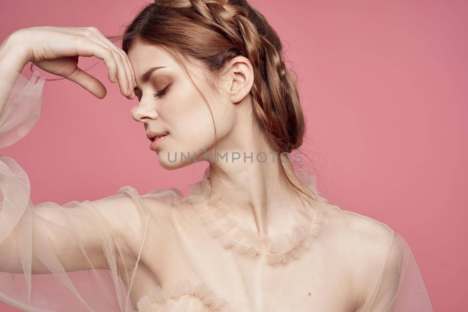 pretty woman in dress fashion hairstyle posing luxury pink background. High quality photo