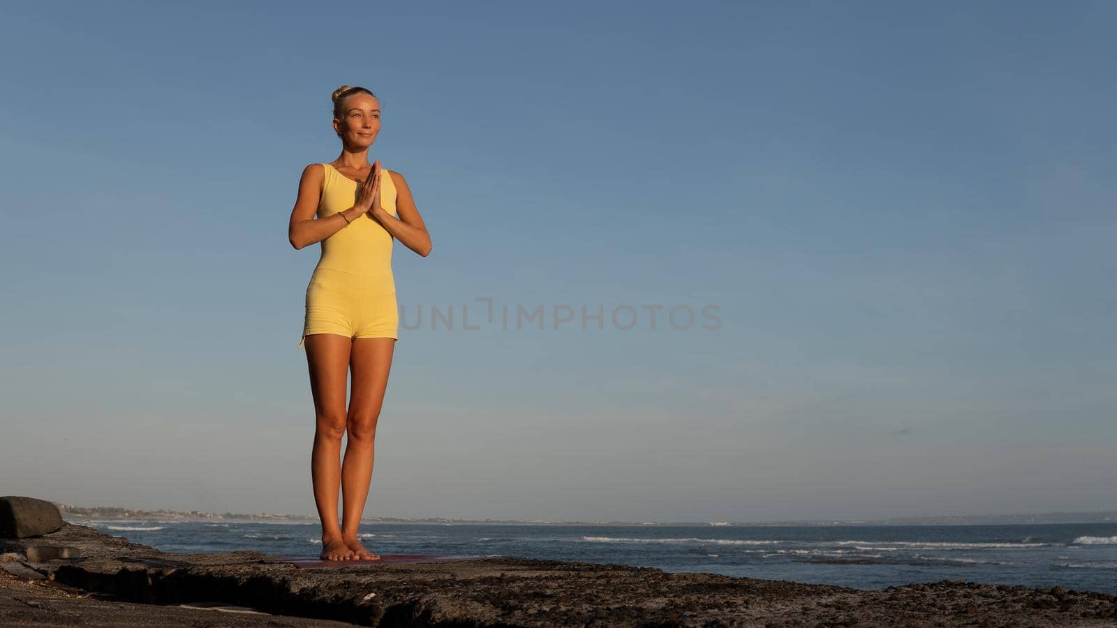 beautiful woman doing yoga on the beach. bali