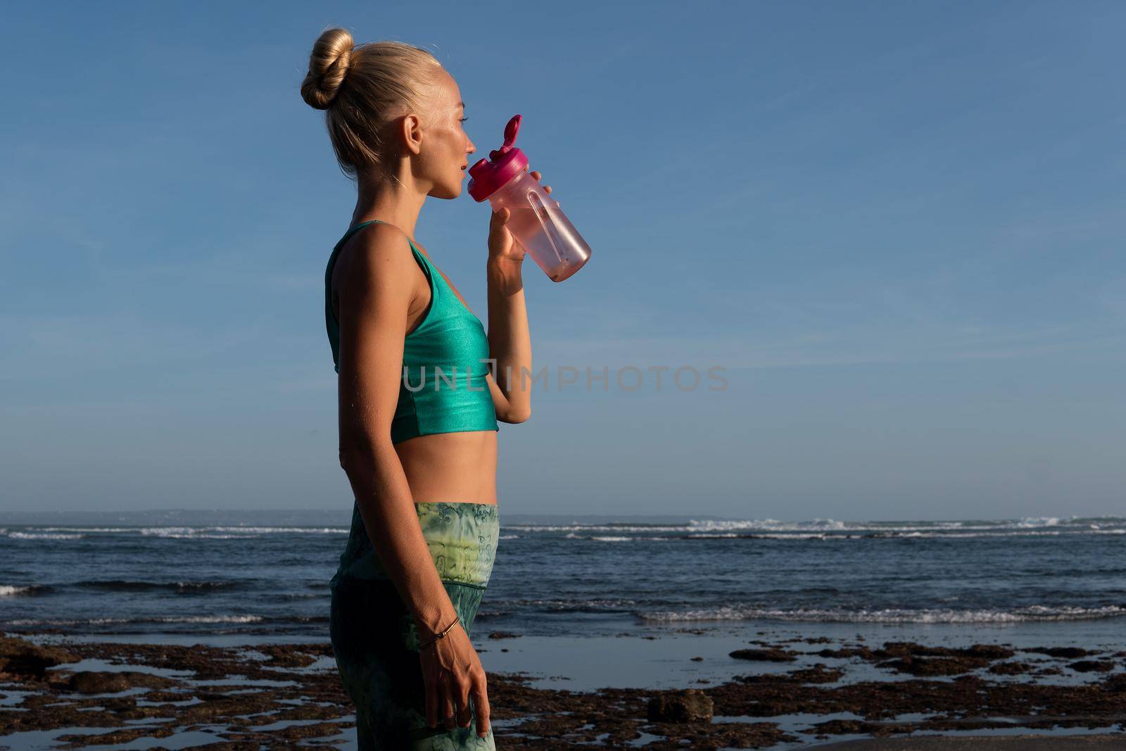 beautiful woman in green drinking water. bali