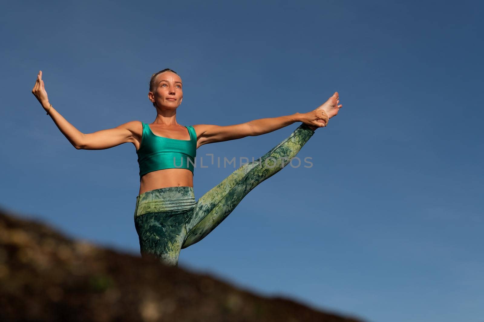 beautiful woman doing yoga by Alexzhilkin